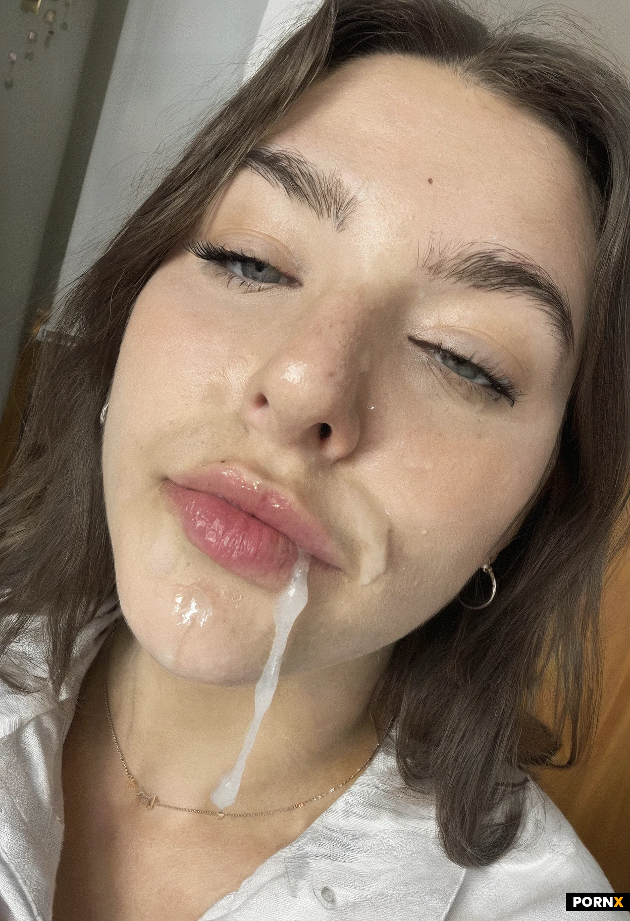 18 year old woman college dorm hallway baggy shirt underpants cum on her lips eye contact 2010s