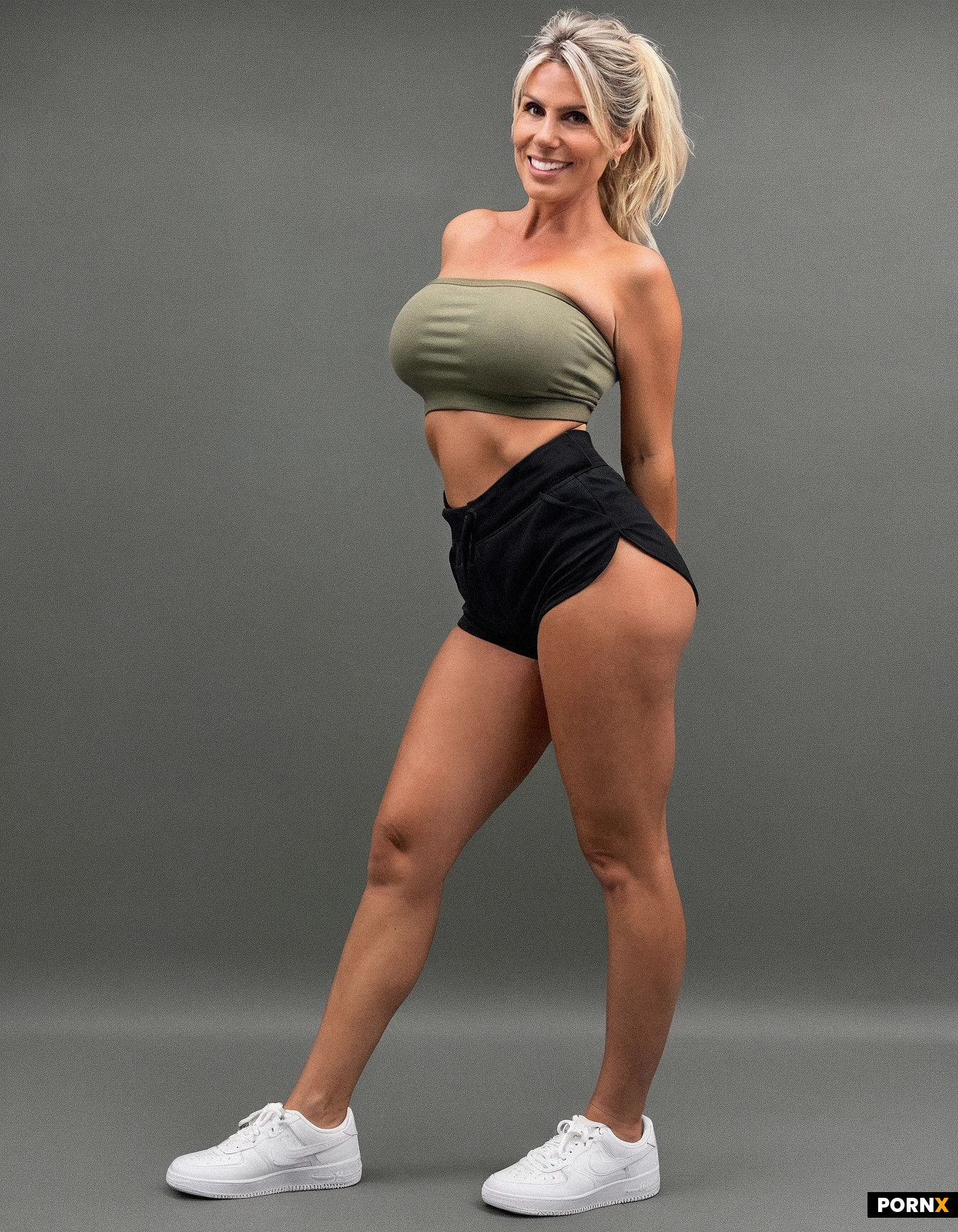45-year-old white woman, full body view, standing, smiling, platinum blonde ponytail, tan lines, wearing olive tube top, black shorts, busty, blank background