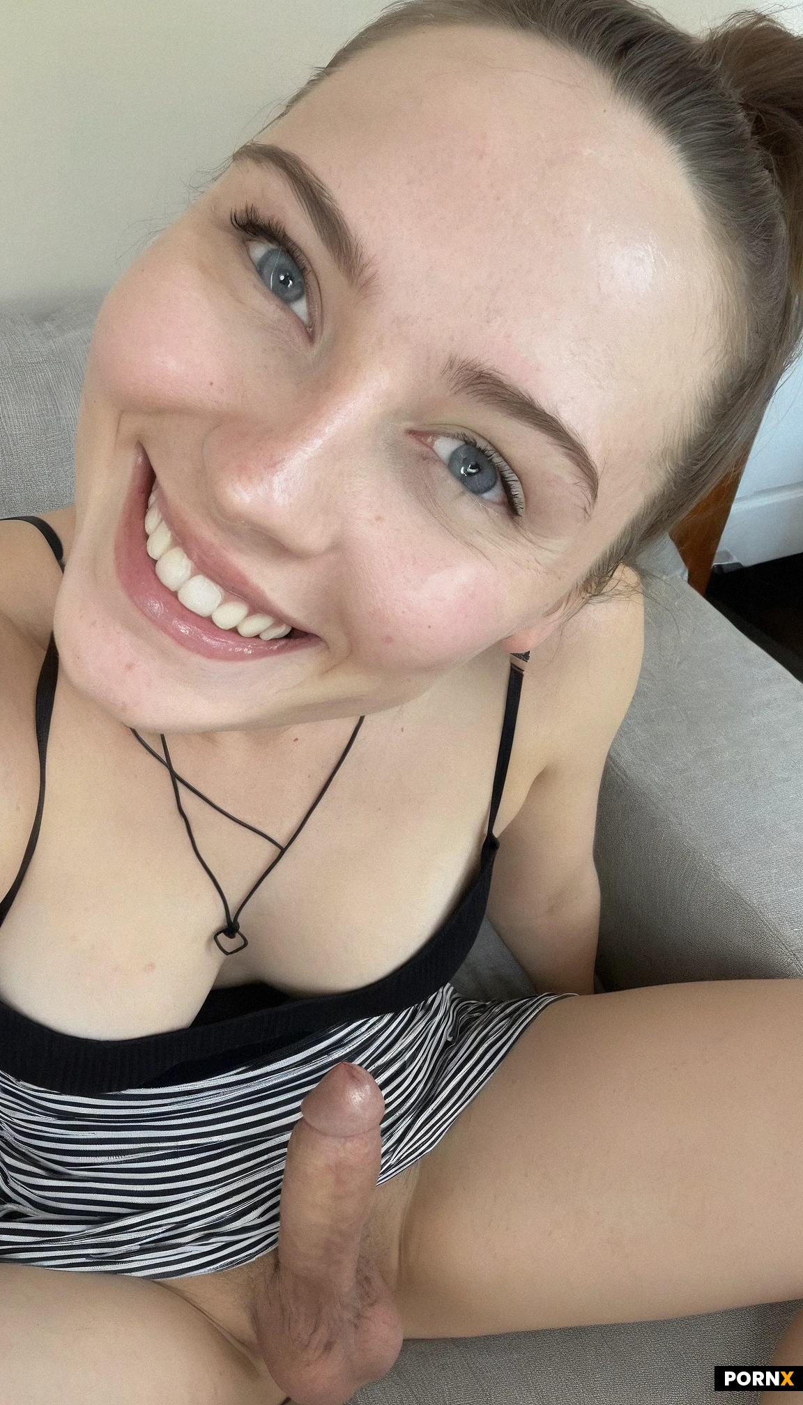 (Close up view) of One (adorable) American woman sitting on couch,pale skin,23 years old,laughing,flirty,smiling,(blushing),simple black sundress,(beautiful face),brunette hair,blue eyes,(no makeup),small breasts,living room,looking at viewer,simple ponytail,simple background,(close up view),flaccid penis,<lora:054:0.5>,testicles,cute face,solo,view from above,spread legs