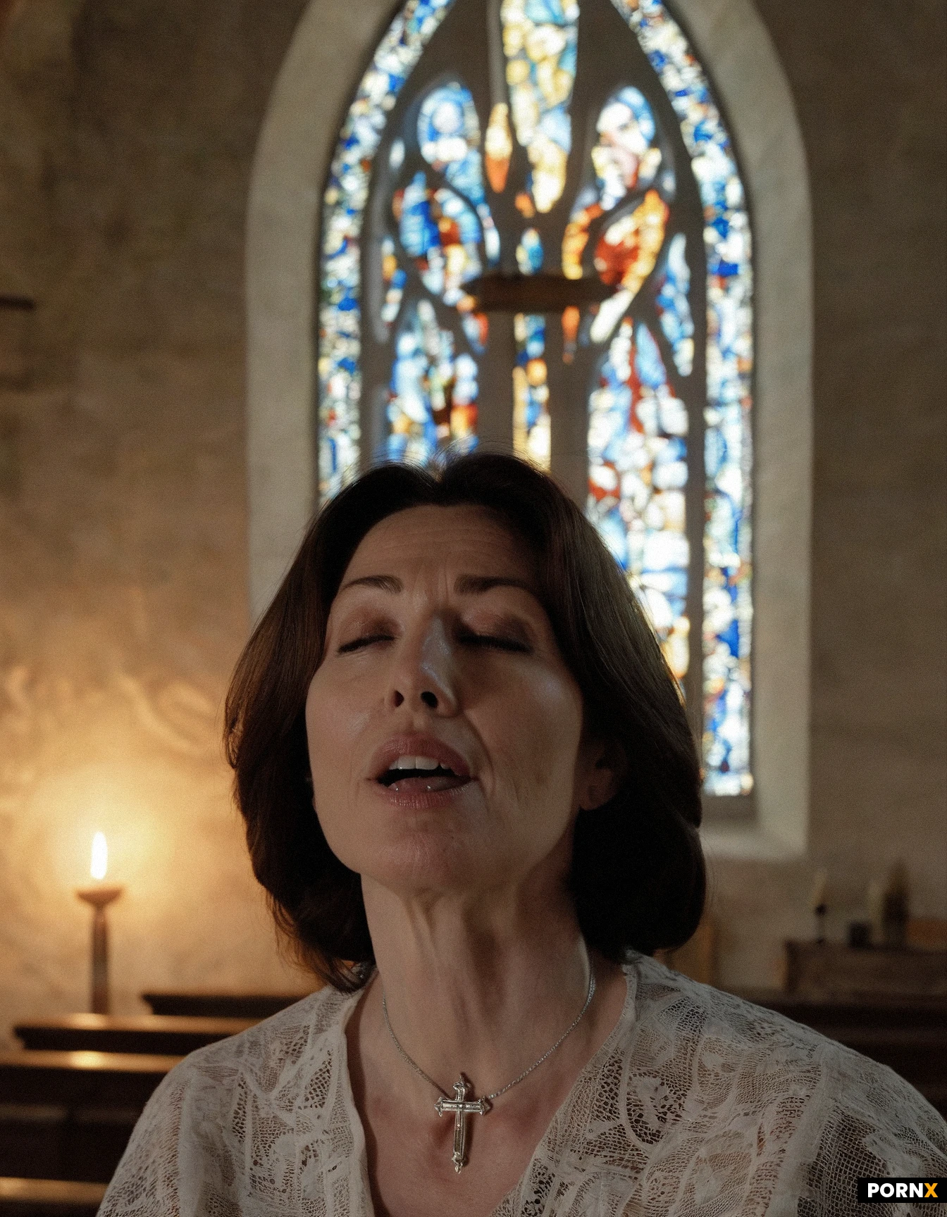 A realistic, medium shot from above of a humble 40-year-old woman, an everyday mother, inside a dimly lit traditional church. Her eyes are gently closed in deep prayer and devotion, with a serene and peaceful facial expression. Her mouth is softly open, presenting her tongue to reverently receive the Holy Eucharist host. She is wearing a simple, modest blouse and a small, discreet silver cross necklace. Soft candlelight and sacred atmosphere, warm divine glow filtering through stained glass, authentic photography, hyper-realistic skin texture, 8k resolution, emotional and spiritual mood --ar 4:3