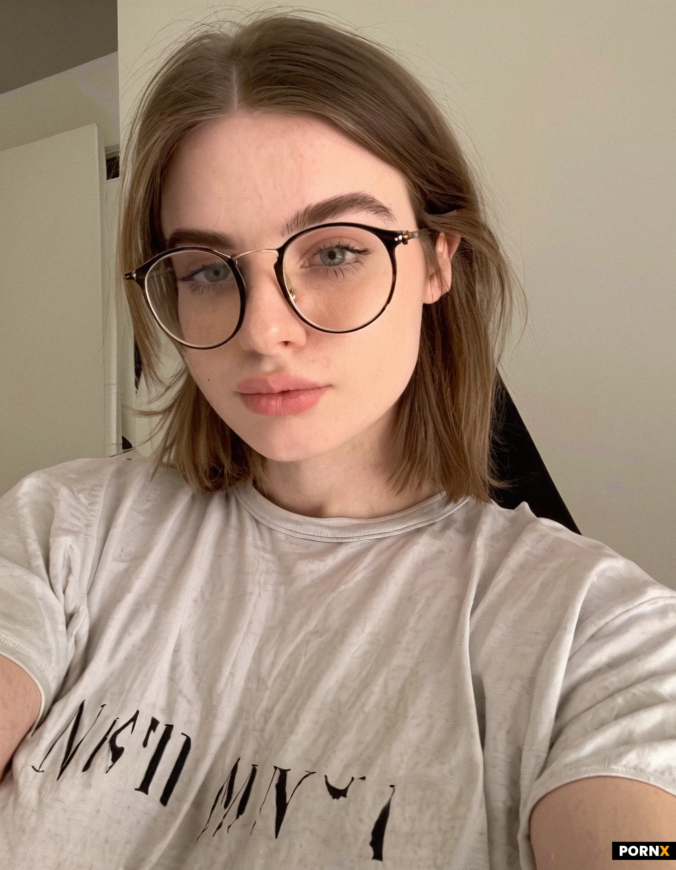 Selfie, woman, pretty, 18_years_old, glasses, T-shirt, warm_light, brunette, pale, close_up