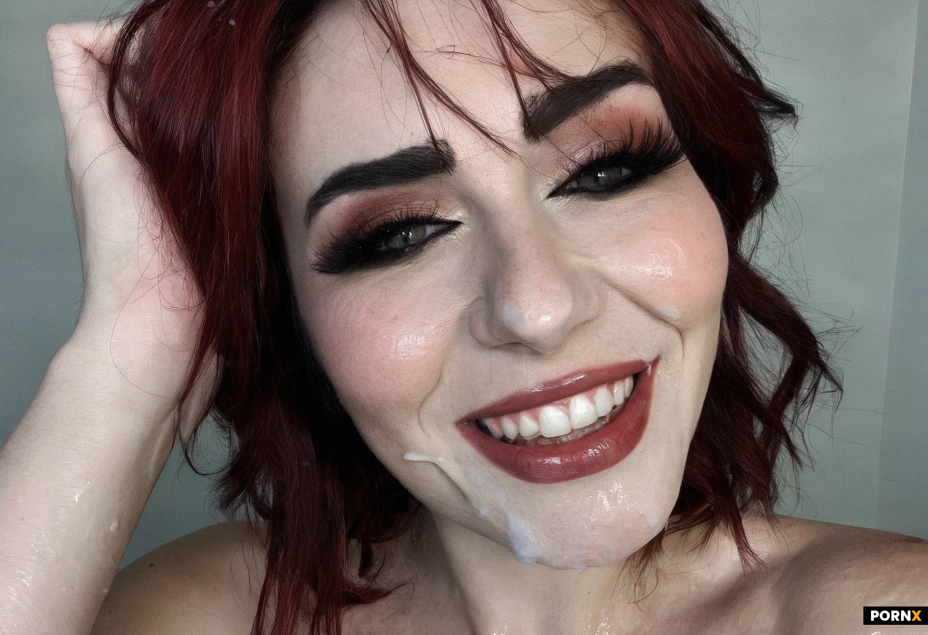 "Realistic amateur photograph, close-up on her face. Genuine happy smile now visible despite exhaustion. Red cheeks, smeared mascara, wet messy hair stuck to forehead. Her eyes are teary but full of love and devotion. She's looking slightly up, as if at someone standing above her. Intimate portrait."