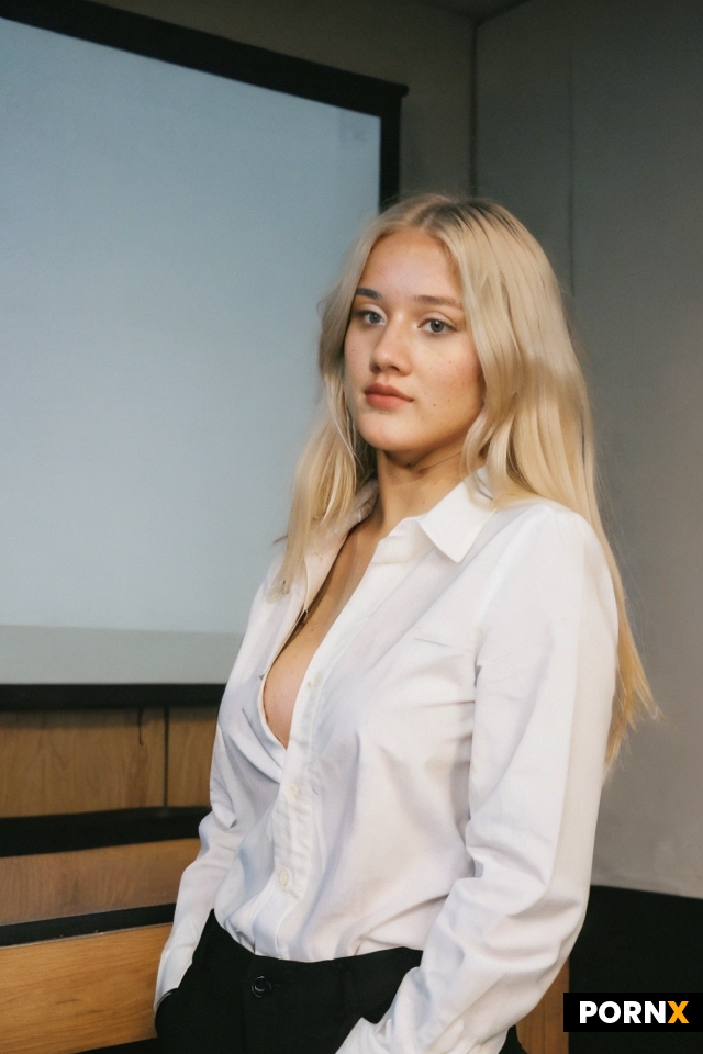 A 20 years old woman who is giving a presentation to her class and her shirt has come unbuttoned and