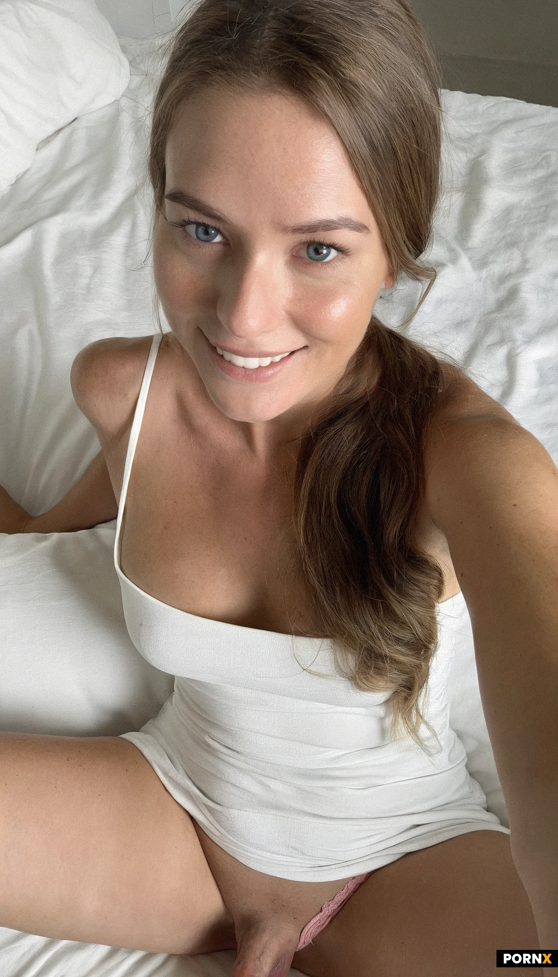 Close up view of One (cute) American woman sitting relaxing,25 years old,smiling,simple white sundress,pink panties,brunette hair,blue eyes,small breasts,bedroom,looking at viewer,simple ponytail,simple background,(close up view),flaccid penis,<lora:054:0.5>,view from above,cute face,solo,no makeup,spread legs
